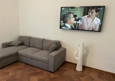 a living room with a couch and a flat screen tv at StarHome San Paolo in Rome