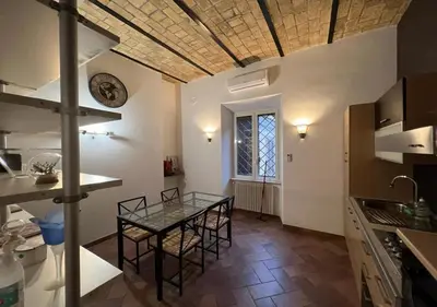 a kitchen with a table and chairs in a room at StarHome San Paolo in Rome