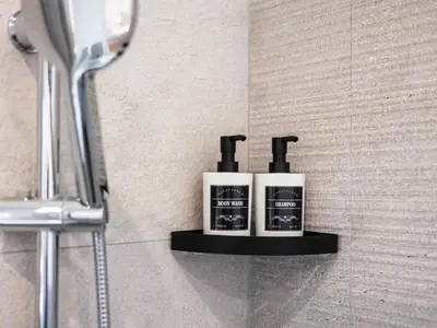 two soap dispensers on a shelf in a bathroom at Majo Suite in Rome