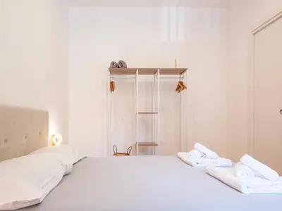 a white bed with two white towels on it at Majo Suite in Rome