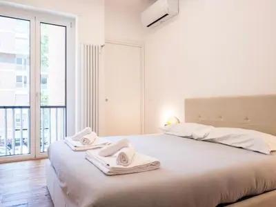 a bedroom with a large bed with towels on it at Majo Suite in Rome
