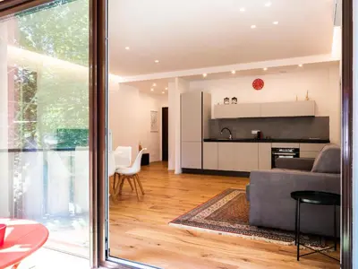 a living room with a couch and a kitchen at Majo Suite in Rome
