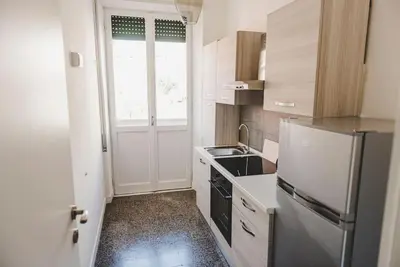 a kitchen with a refrigerator and a sink at La Casa di Klaudia in Rome