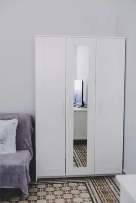 a bedroom with a white cabinet and a bed at La Casa di Klaudia in Rome