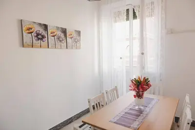 a dining room table with a vase of flowers on it at La Casa di Klaudia in Rome