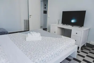 a bedroom with a white bed with a tv on it at La Casa di Klaudia in Rome