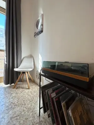 a room with a piano and a white chair at Eufonia Gemelli Apartment in Rome