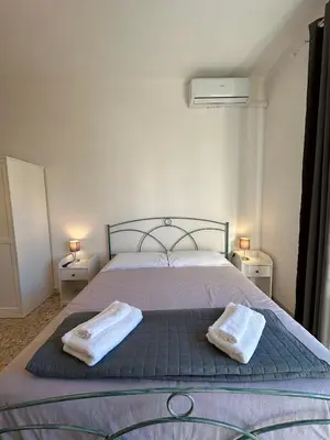 a bedroom with a bed with two towels on it at Eufonia Gemelli Apartment in Rome