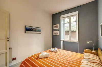 a bedroom with a bed and a window at Monti Coliseum 2nd floor 3 bedroom in Rome