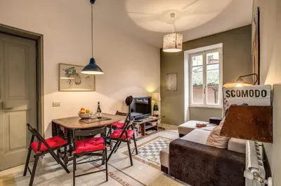 a living room with a table and a couch at Monti Coliseum 2nd floor 3 bedroom in Rome