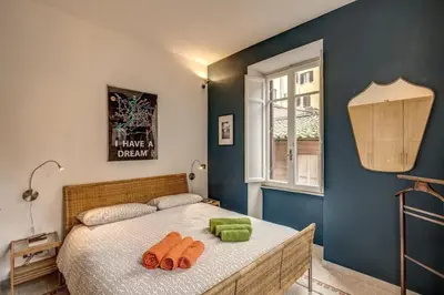 a bedroom with a bed with two towels on it at Monti Coliseum 2nd floor 3 bedroom in Rome