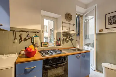 a kitchen with a sink and a stove top oven at Monti Coliseum 2nd floor 3 bedroom in Rome