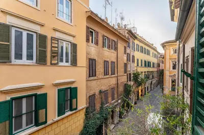 an alley in an old city with buildings at Nora's Home, Charmy Apt in the Heart of Trastevere in Rome