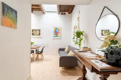a living room with a couch and a table at Nora's Home, Charmy Apt in the Heart of Trastevere in Rome