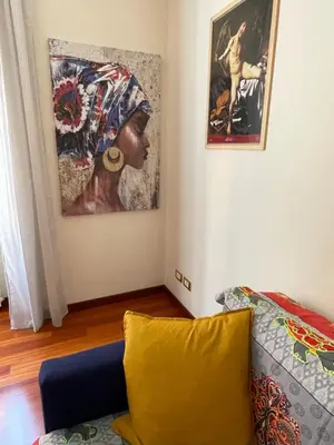 a living room with a couch and a painting on the wall at Casa Alessi in Rome elegant, spacious and comfortable apartment in Rome