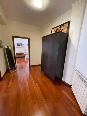an empty room with a wooden floor and a cabinet at Casa Alessi in Rome elegant, spacious and comfortable apartment in Rome