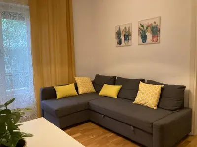 a living room with a gray couch with yellow pillows at FAIROME Apartment Farnesina in Rome