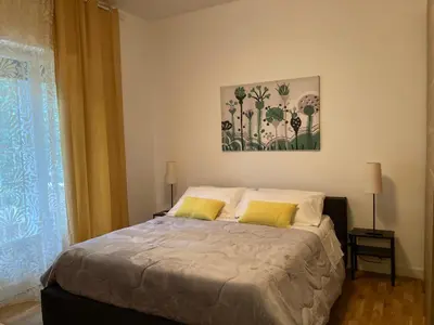 a bedroom with a bed with two yellow pillows at FAIROME Apartment Farnesina in Rome