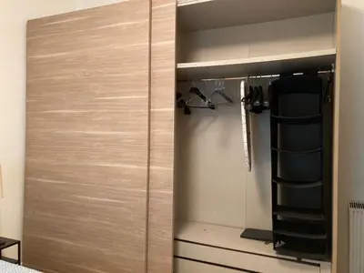 a closet with a wooden door in a room at FAIROME Apartment Farnesina in Rome
