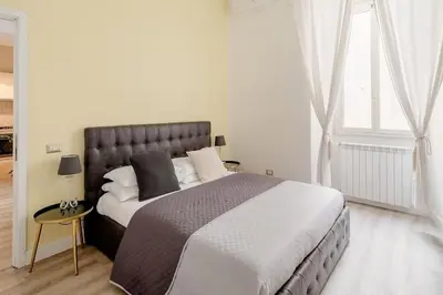 a bedroom with a large bed and a window at A casa di Clara in Rome
