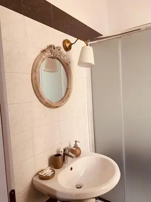 a bathroom with a sink and a mirror at A casa di Clara in Rome