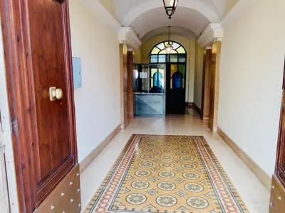 a hallway with a door and a rug on the floor at A casa di Clara in Rome