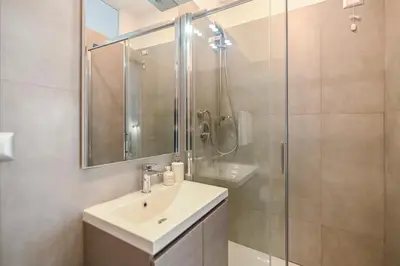 a bathroom with a sink and a glass shower at Suite 109 in Rome