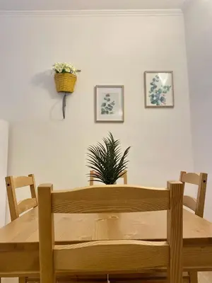 a wooden table with a potted plant on the wall at Casetta Marconi Trentotto in Rome
