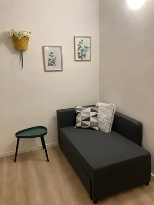 a black couch in a living room with a table at Casetta Marconi Trentotto in Rome