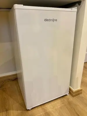a white refrigerator sitting on the floor in a room at Attico Loft con terrazza Vía dei Coronari - Roma in Rome