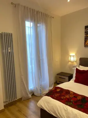 a bedroom with a bed and a window with curtains at Attico Loft con terrazza Vía dei Coronari - Roma in Rome