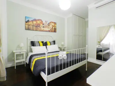 a bedroom with a bed and a painting on the wall at Nice Apartment with Balcon in Rome