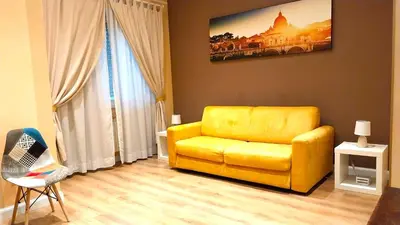 a living room with a yellow couch and a window at Nice Apartment with Balcon in Rome