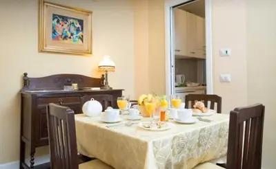 a table with food and drinks on it in a room at Nice Apartment with Balcon in Rome