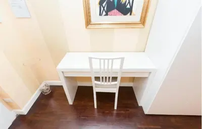 a white desk with a chair in a room at Nice Apartment with Balcon in Rome