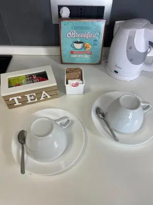 a white table with a tea set and a coffee maker at Henry Suite in Rome