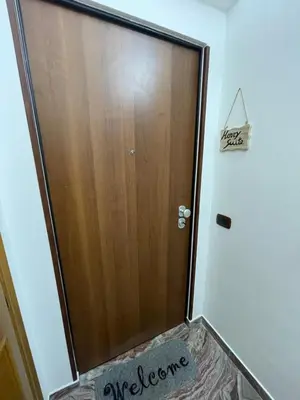 a wooden door in a room with a rug in front of it at Henry Suite in Rome