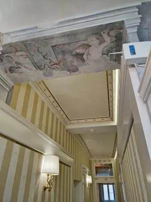a painting on the ceiling of a hallway at Piazza Venezia Luxury Suite in Rome
