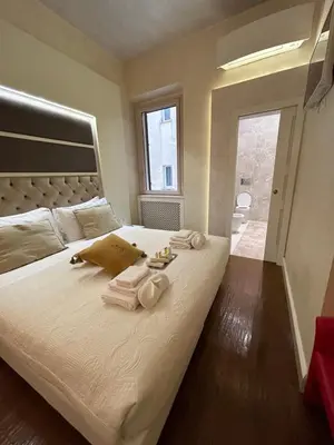 a bedroom with a large bed with towels on it at Piazza Venezia Luxury Suite in Rome
