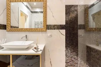 a bathroom with a sink and a mirror at Piazza Venezia Luxury Suite in Rome