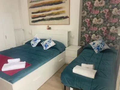 a bedroom with two twin beds with towels on them at Casa di Mochi in Rome