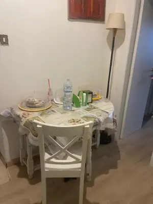 a white table with two white chairs and a table with at Casa di Mochi in Rome