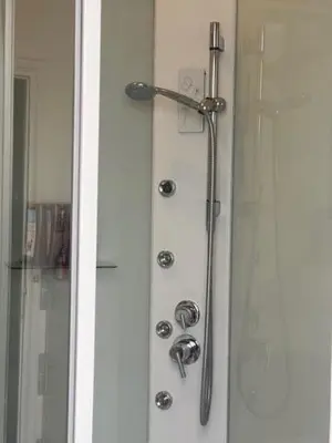 a shower with a shower head on a door at Casa di Mochi in Rome
