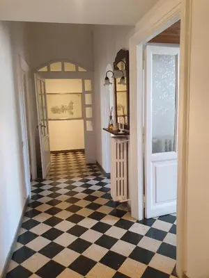 a hallway with a black and white checkered floor at Home Rome Lepanto in Rome