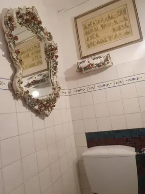 a bathroom with a mirror and a toilet at Home Rome Lepanto in Rome