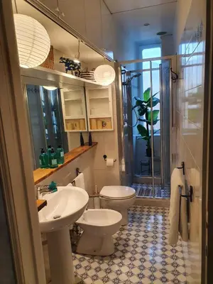 a bathroom with a toilet and a sink and a shower at Home Rome Lepanto in Rome