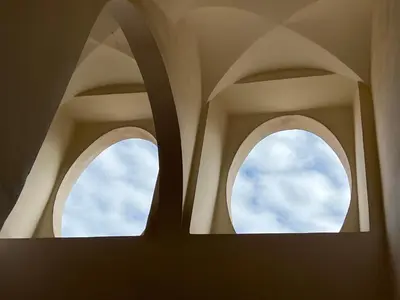 two windows in a building with the sky in the background at Colosseo Suite in Rome