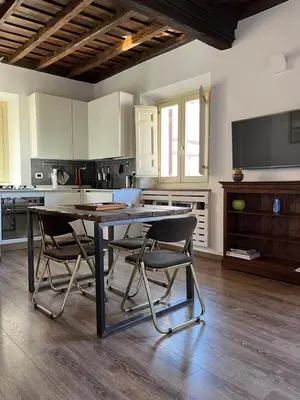 a kitchen with a table and chairs in a room at Colosseo Suite in Rome
