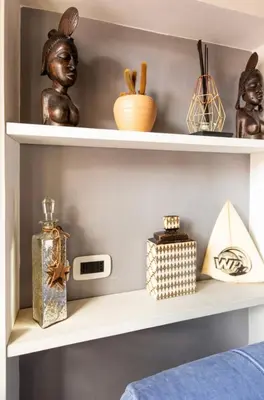 a shelf with various items on it at Colosseo Suite in Rome