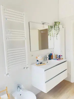 a white bathroom with a sink and a mirror at Gemelli-San Pietro-Trastevere-casa con posto auto in Rome